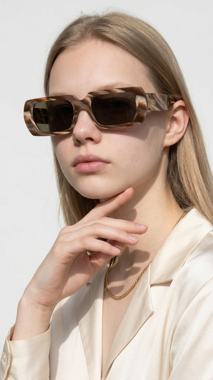 Front view of woman wearing CONFILVARO oversized brown tortoiseshell-effect rectangle sunglasses with dark lenses

