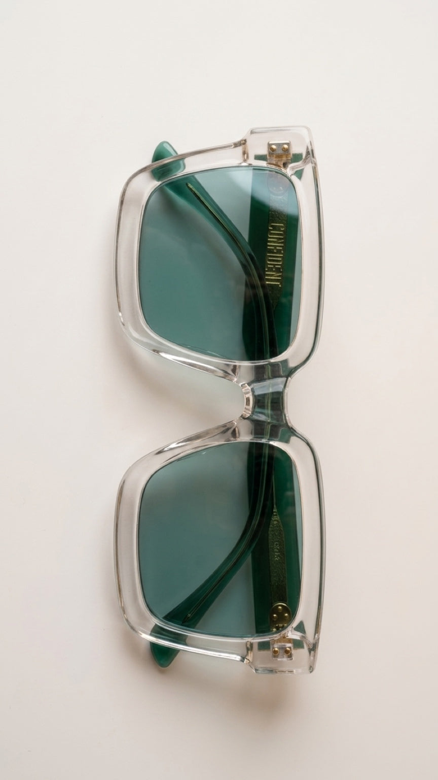 Top view of folded CONFILVARO transparent green rectangle sunglasses with green lenses