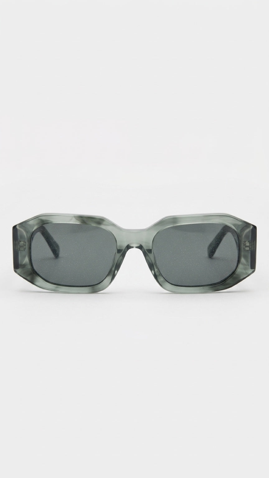Oversized square sunglasses with a translucent smoky green and gray acetate frame and dark gray lenses, shown against a plain light gray background.