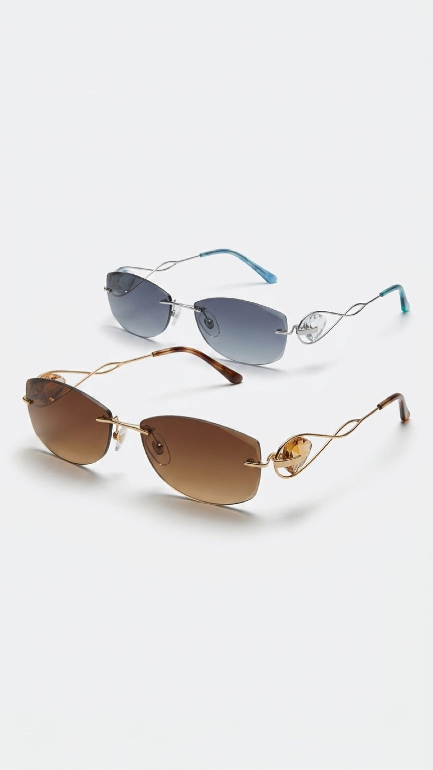 Two pairs of rimless sunglasses displayed on a light gray background. The top pair features blue-tinted lenses and light blue temple tips with a silver metal frame.