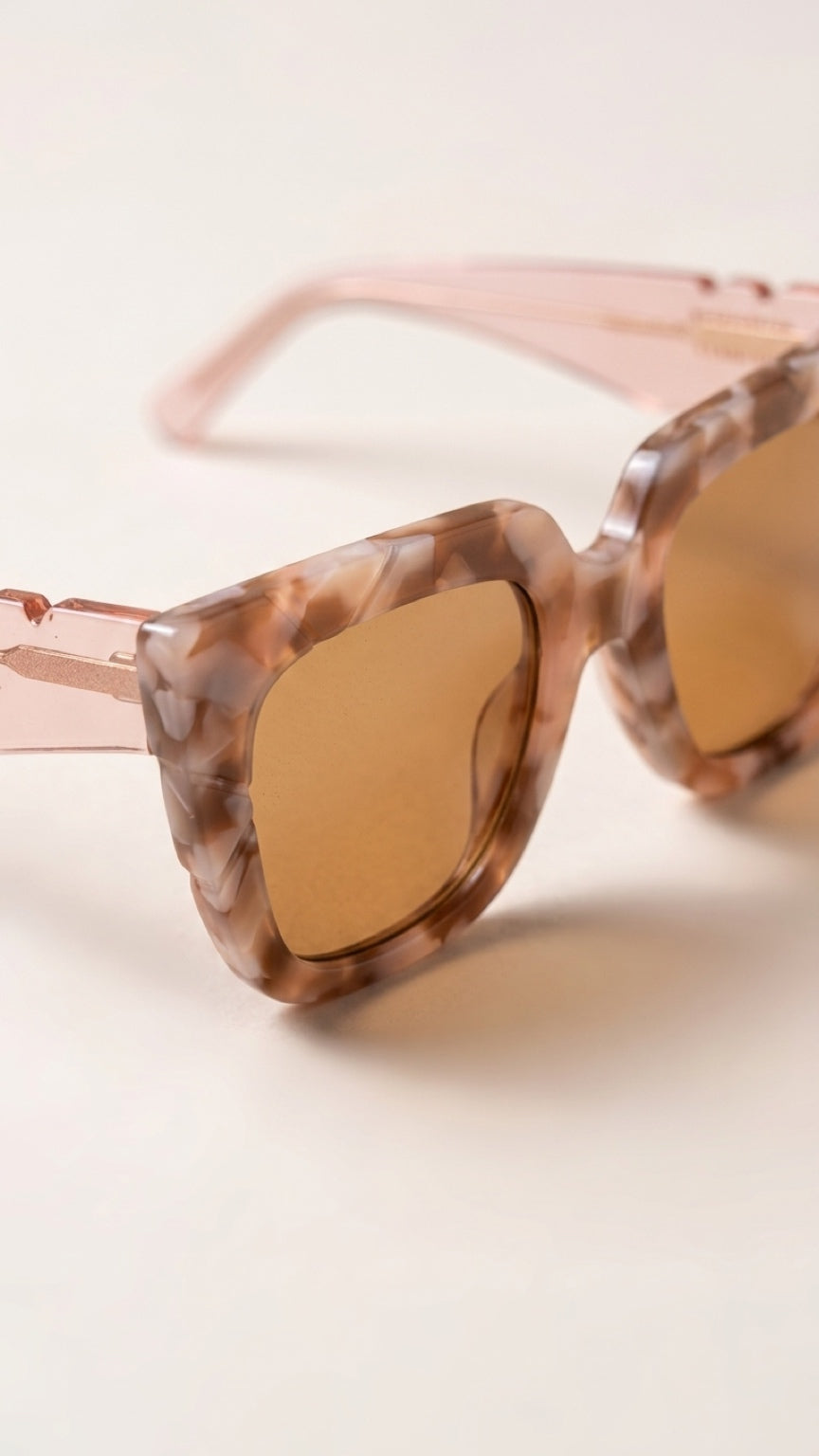 Close-up of CONILVARO pink tortoiseshell-effect acetate frame and brown gradient lenses