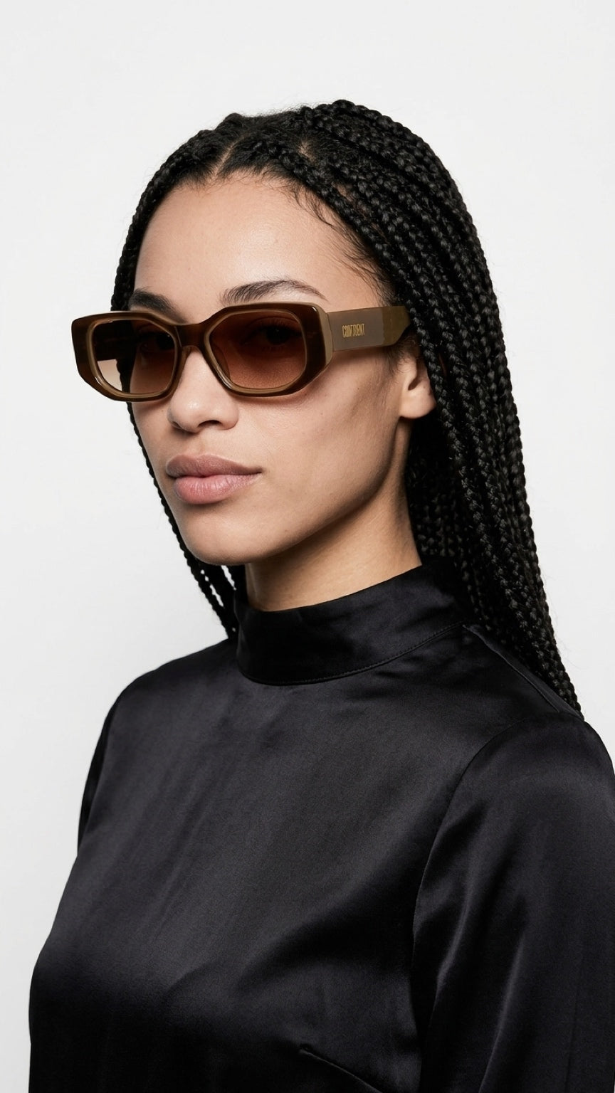 Woman in black wearing CONFILVARO brown tortoiseshell-effect rectangle sunglasses
